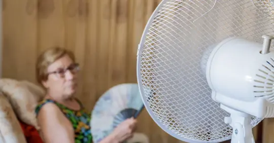 Woman using fan